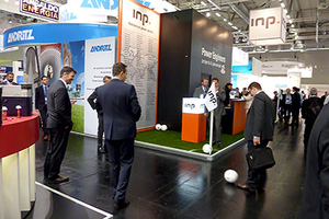 INP team and customers play soccer next to INP booth